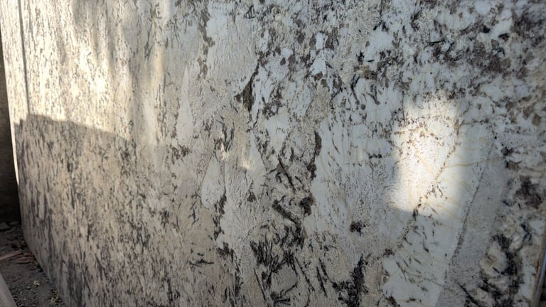 Close-up of weathered concrete wall with dark mold and mildew stains and patches of peeling paint