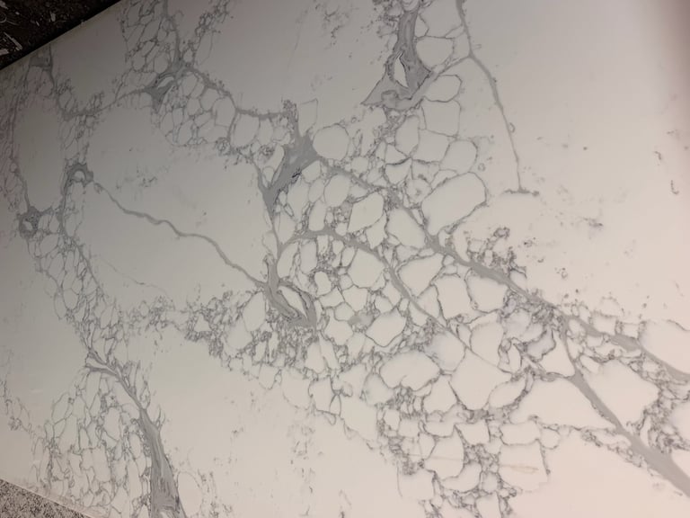 Cracked white surface with branching lines and patterns resembling dried mud or concrete deterioration