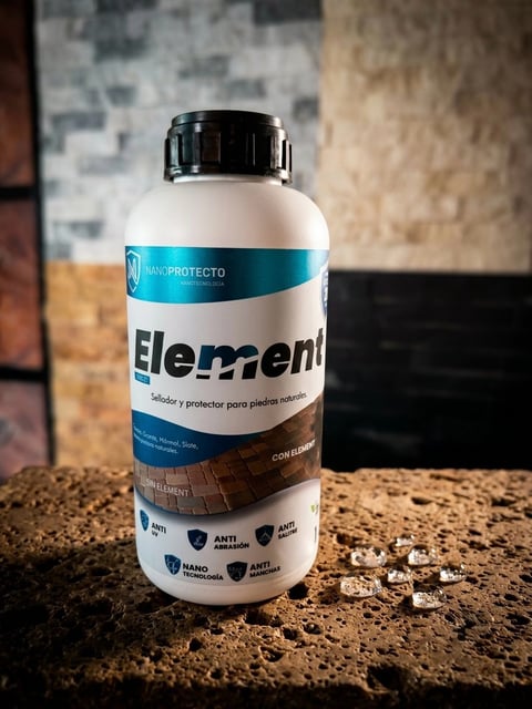 White plastic bottle of Element sealer and protector for stone surfaces, displayed on textured ground with brick wall background