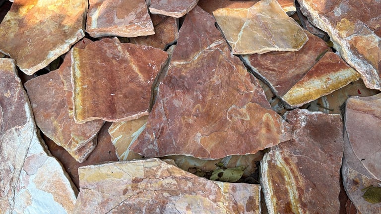 Close-up of irregular reddish-brown stone tiles or slate pieces arranged together