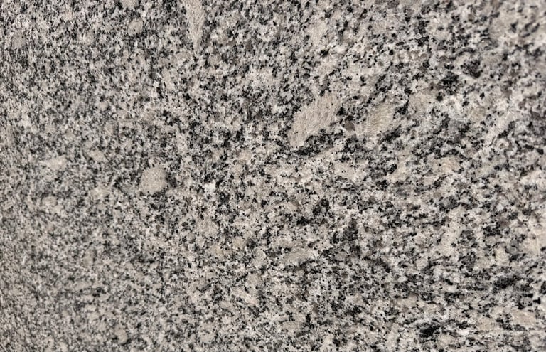 Close-up of gray granite surface with black and white speckled texture
