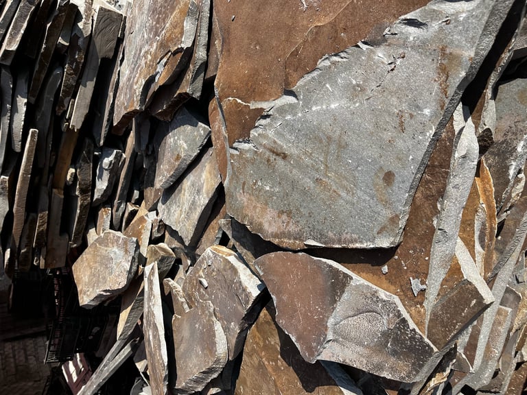 Close-up of layered slate rock formations with jagged edges and natural striations in brown and gray tones